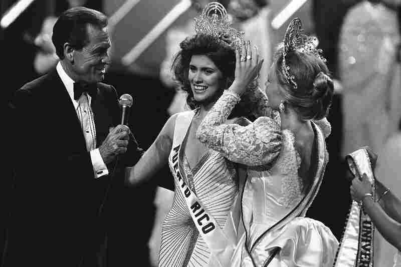 Miss Universe Deborah Carthy-Deu, of San Juan, smiles as she is crowned by Barker after the end of the 1985 pageant. Barker, a committed animal rights advocate, hosted Miss USA and Miss Universe for over two decades, resigning when producers refused to stop handing out fur coats as part of prize packages.