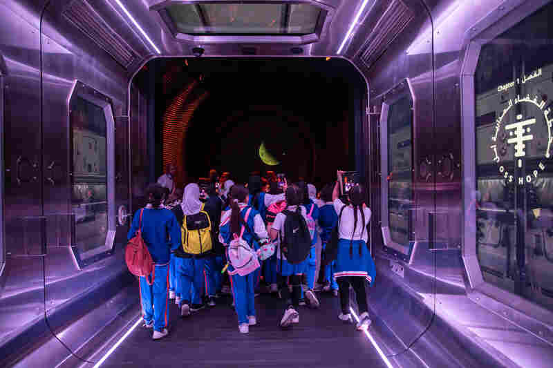 School children take pictures during the Space Shuttle Simulation in part of the Museum of the Future's space exhibition. The Museum's experience aims to highlight the possibilities of human space travel in the future.